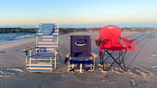 Ostrich, Tommy Bahama, and Coleman beach chairs on a beach