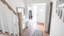 An entryway to a house where jackets and shoes are kept
