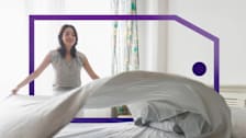 Woman making a bed, lifting a sheet in a bright, framed by a purple outlined price tag