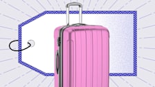 A pink, hard-shell suitcase in front of a large purple-bordered price tag graphic, set against a background with subtle purple lines radiating outward.