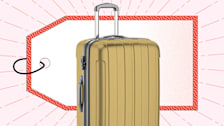 A gold, hard-shell suitcase in front of a large red-bordered price tag graphic, set against a background with subtle purple lines radiating outward.
