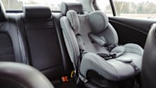 View of a car seat in the back seat of a car.