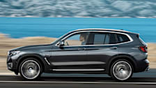2022 BMW X3 driving by lake