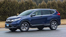 blue 2017 Honda CR-V on asphalt with trees and grass in background