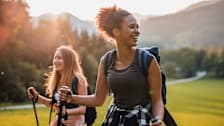 Two women hiking on a sunny day.