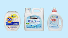 Tide Plus Hygienic Clean 10X, Kirkland Signature (Costco) UltraClean Free & Clear, and Persil Everyday Clean Free & Sensitive laundry detergents on orange and brown background