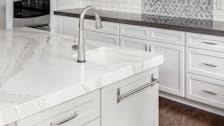 A residential kitchen with different countertop materials used throughout.