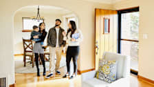 a family viewing a house for sale with a realtor.