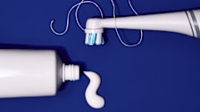 an electric toothbrush, floss and toothpaste