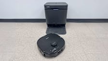 Eureka J15 Max Ultra base and vacuum on tan floor with grey wall