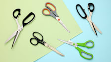 Five pairs of scissors on green and blue paper