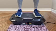Consumer Reports editor testing the Lifepro Waver Vibration Plate Exercise Machine in her home.
