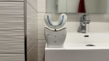 The Autobrush sitting on the ledge of a bathroom sink.
