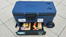 The Ninja Frost Vault seen with its dry storage drawer open with perishable snacks inside.