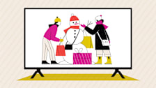 Two people building a snowman with shopping bags and gifts, shown on a large television screen.