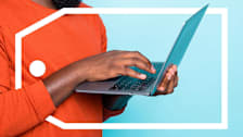 Man using a laptop surrounded by a deals tag.