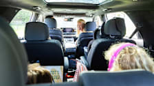 Family in large 3-row vehicle