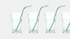 Four glasses of water with a straw.