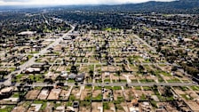 An aerial view shows empty lots and new homes under construction in Altadena, California on January 5, 2026.