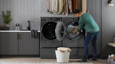 a person doing laundry with a LG DLEX6700B Clothes Dryer