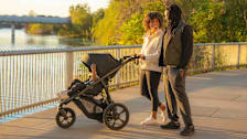 Couple standing with child in BOB Wayfinder Jogging Stroller