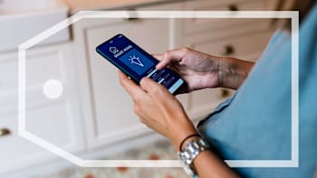 Person accessing their smart home apps on their cell phone