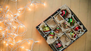 Christmas lights and baubles on wood floor