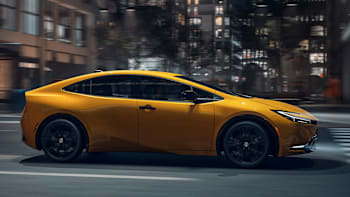 2025 Toyota Prius Nightshade driving through city at night