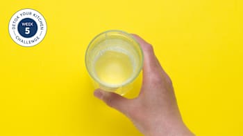 a hand holding a glass of water
