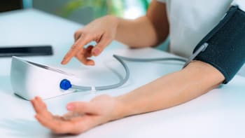close up of a person using a blood pressure monitor