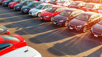 Used Vehicles For Sale Awaiting on the Dealer Parking Lot.