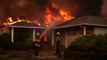 Firefighters battle flames from the Palisades Fire on January 8, 2025 in the Pacific Palisades neighborhood of Los Angeles, California