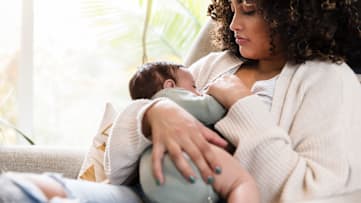 Woman breastfeeding newborn