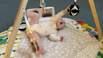 a baby playing in Lovevery The Play Gym