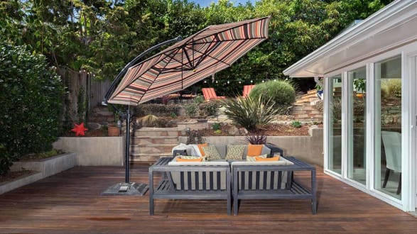 wooden patio with chairs and umbrella