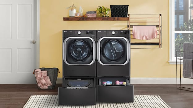 LG WM8900HBA washing machine and DLEX8900B/DLGX8901B dryer in room with yellow walls and white door