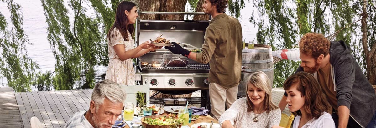 people using Weber grill outside