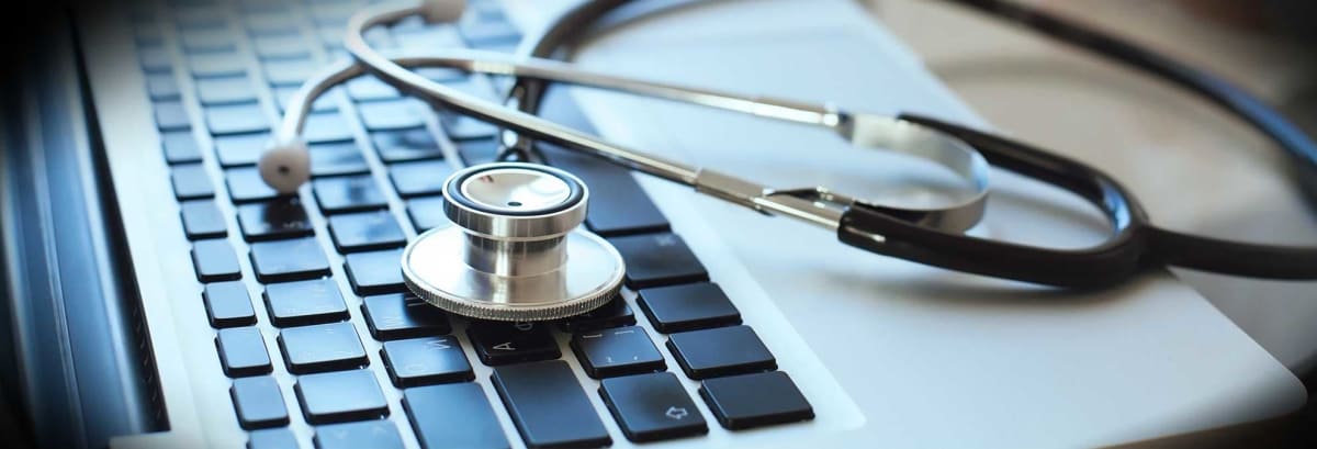 Stethoscope sitting on laptop
