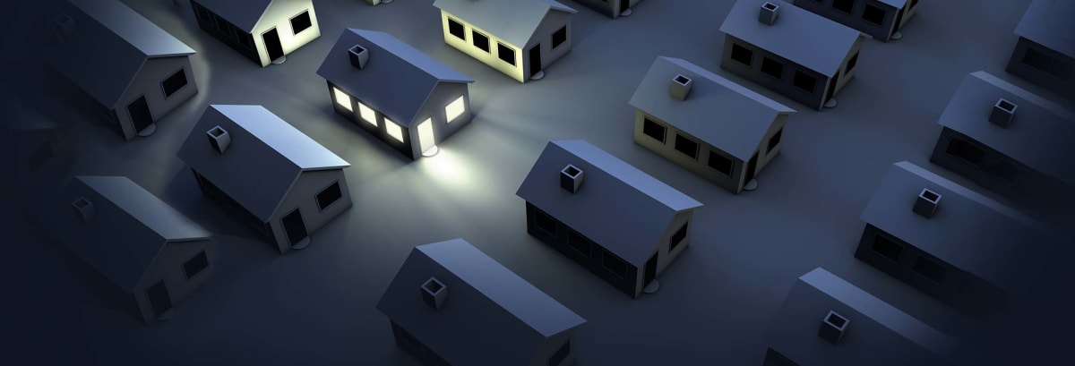 illustration of rows of dark houses and one house lit up