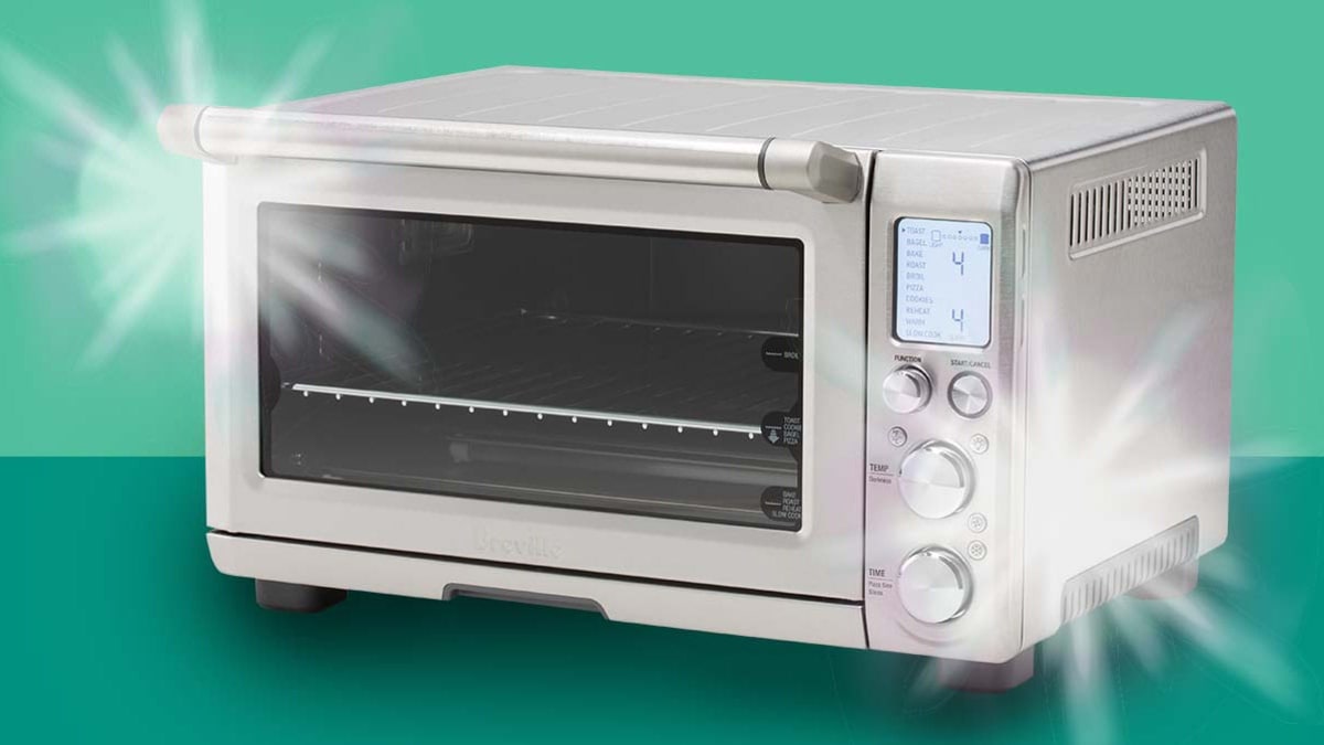 Clean, shiny toaster on green background