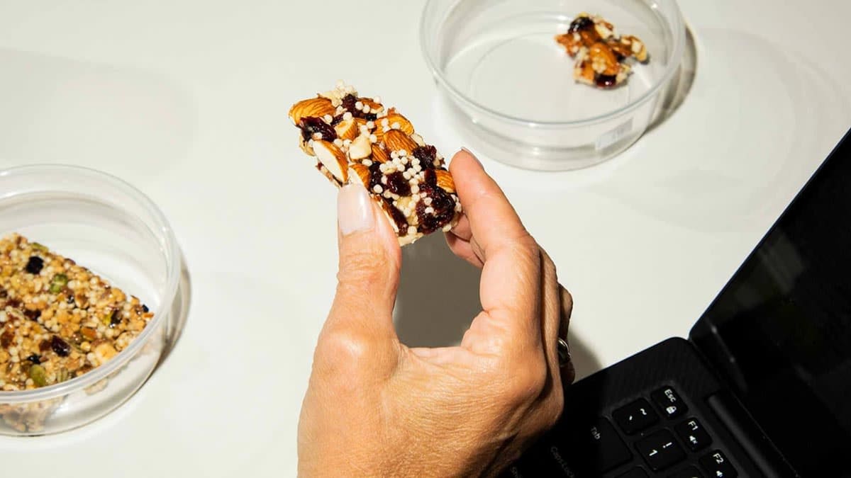 tester holding snack bar