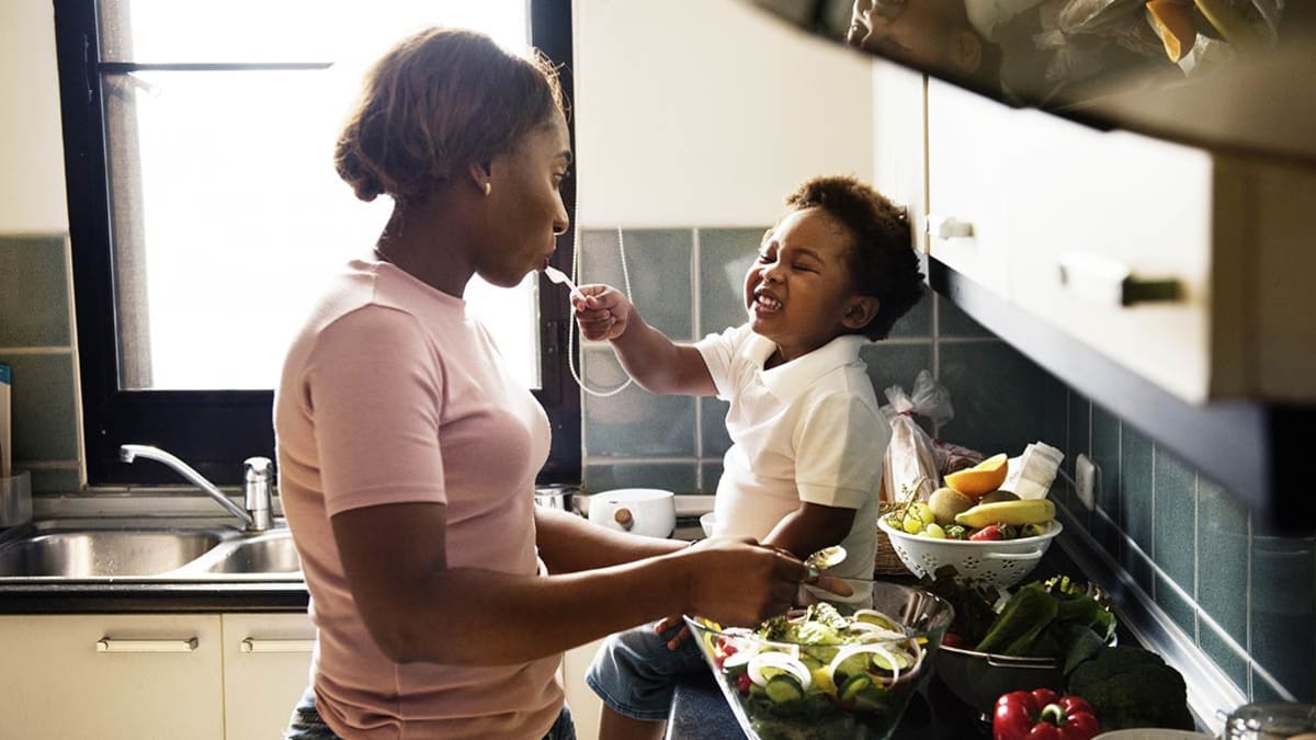 Mother and child cooking in kitchen