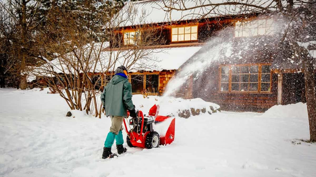 man using snowblower