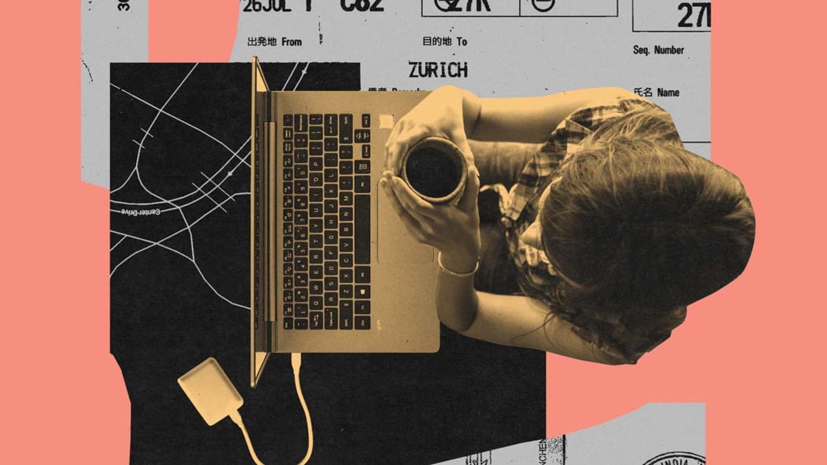 woman sitting in front of laptop holding coffee mug