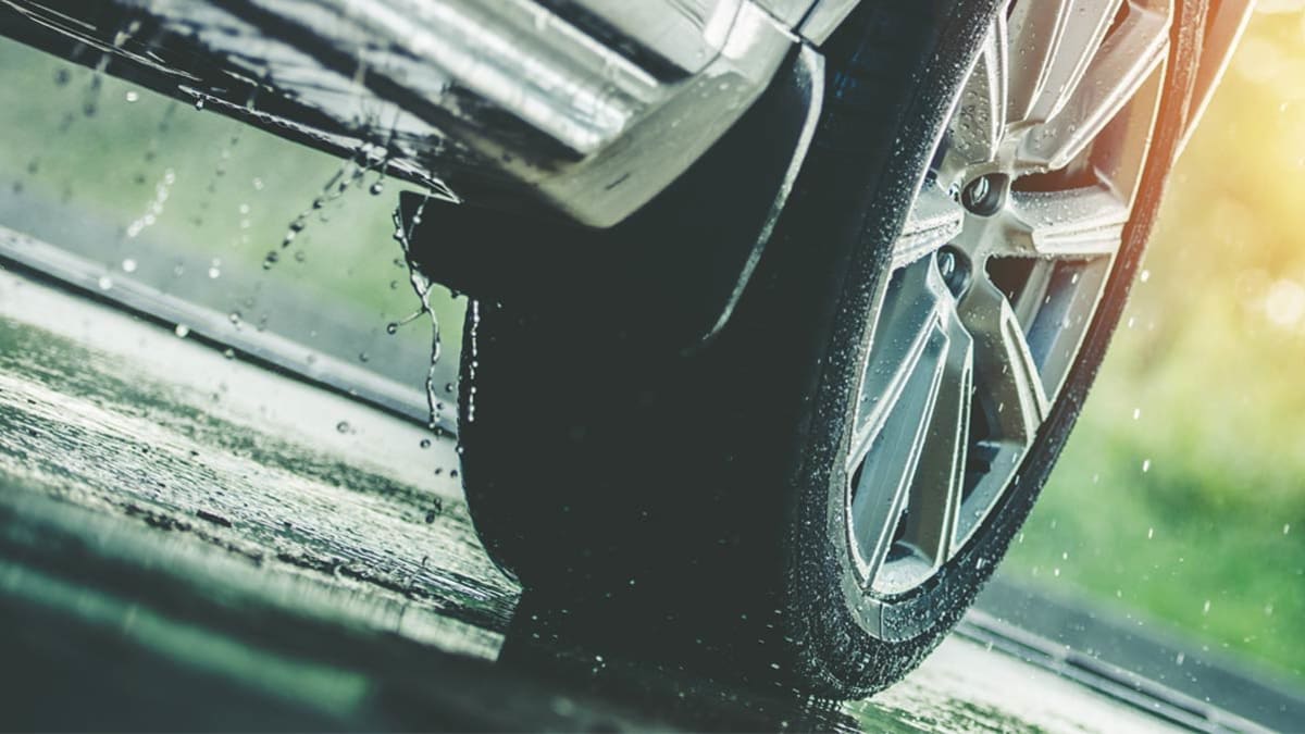 Close up of Car tire driving in the rain