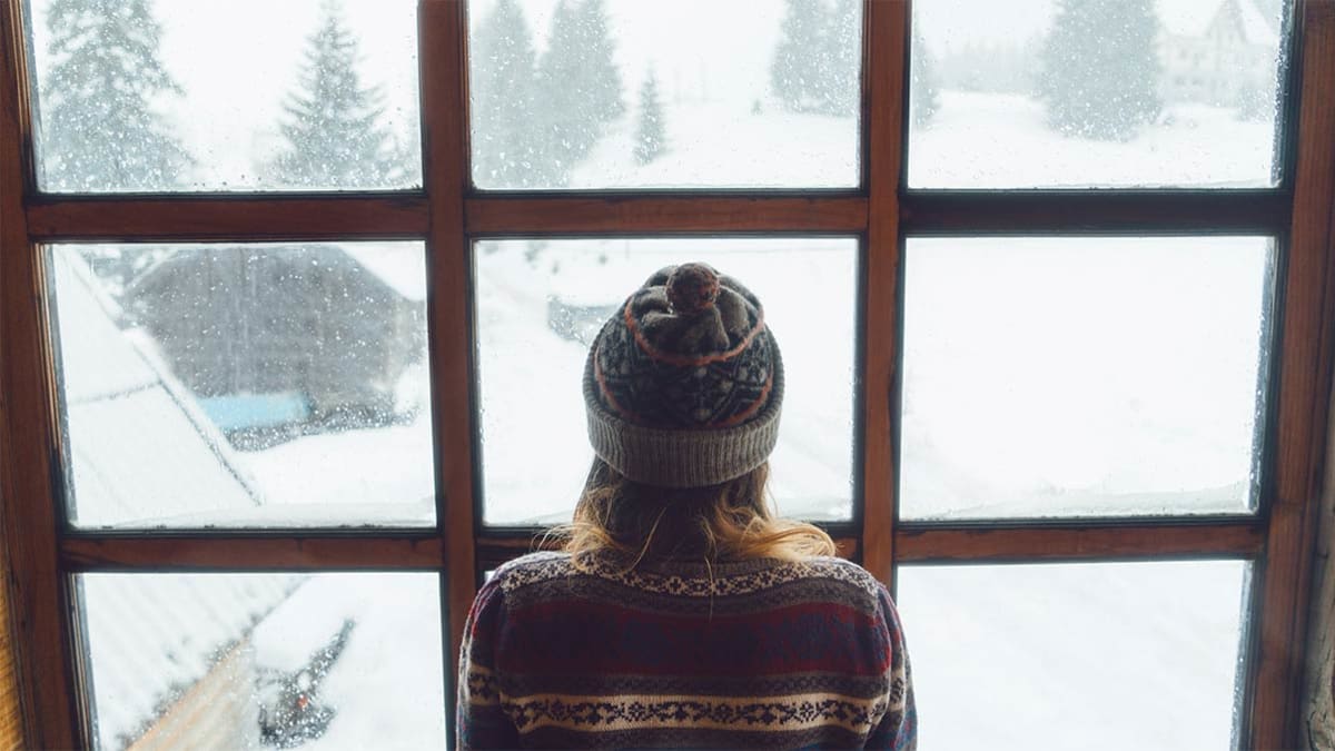 Person looking outside at winter weather