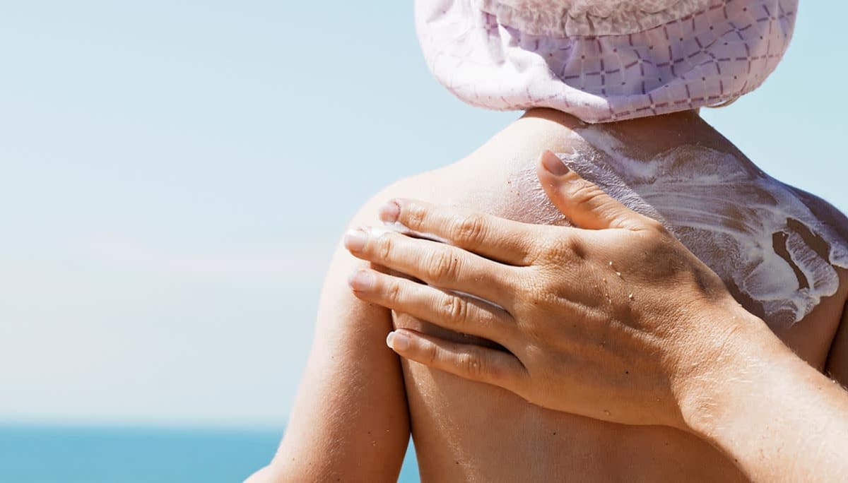 Applying sunscreen to child