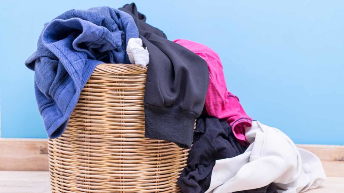 overflowing hamper of laundry