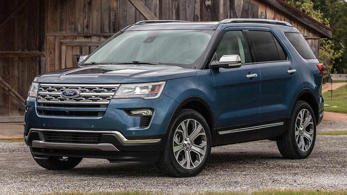 blue 2019 Ford Explorer Limited Luxury Edition on gravel driveway in front of barn