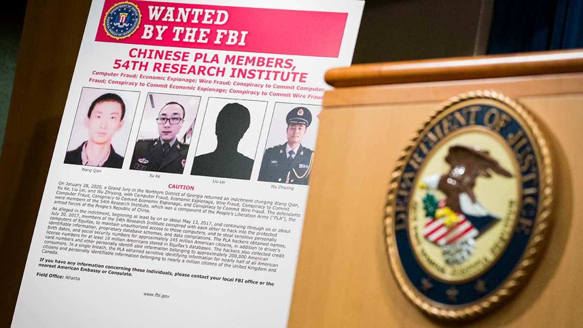 Signs that depict the four members of China's military indicted on charges of hacking into Equifax Inc. and stealing data from millions of Americans are seen shortly after Attorney General William Barr held a press conference at the Department of Justice on February 10, 2020 in Washington, DC. (Photo by Sarah Silbiger/Getty Images)